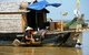Cambodia: Vietnamese woman washing dishes on her houseboat on the Great Lake, Tonle Sap near Siem Reap